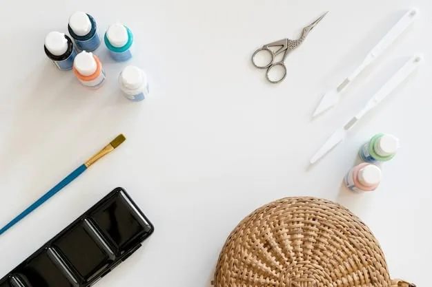A flat lay of various crafting tools and materials including fabric paints, brushes, E6000 glue, rhinestones, and stencils, neatly organized on a wooden table, suggesting a DIY customization project in progress.