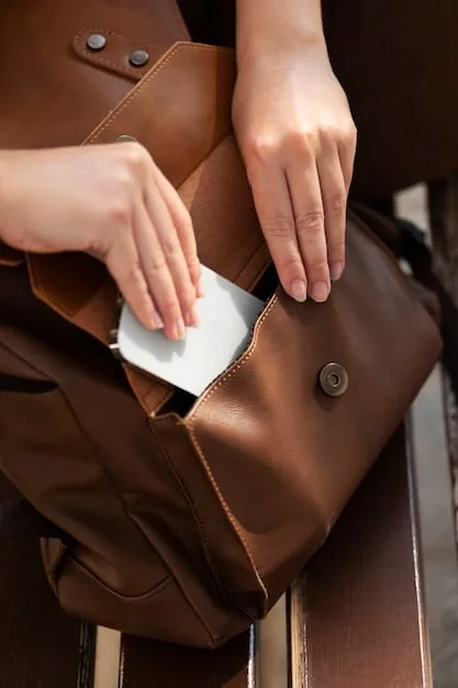A person's hands delicately cleaning a faux leather bag with a soft cloth, demonstrating proper synthetic material care.