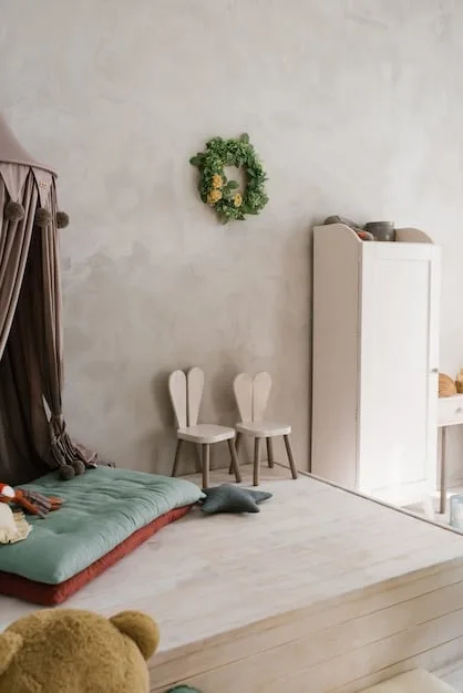A child-friendly room featuring soft, rounded furniture, a plush rug, and wall-mounted shelves displaying neatly organized books and toys, all designed for safety with a neutral color palette.