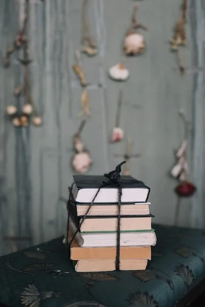A stylish modern farmhouse vignette featuring a stack of vintage-look books tied with twine, a small distressed white vase with faux cotton stems, and a galvanized metal watering can, all artfully arranged on a rustic wooden tray, demonstrating budget-friendly upcycling.