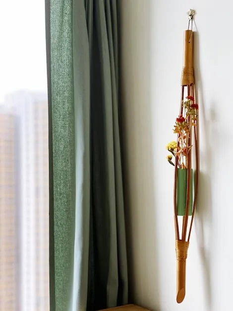 A close-up shot of a SHEIN grommet top curtain in a muted sage green, hanging neatly with visible folds. The fabric shows a subtle texture, and a sliver of light peeks through the grommets, suggesting a room with natural light.