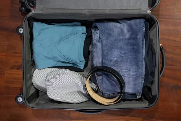 A neatly packed suitcase with a minimalist collection of versatile travel clothes, including foldable pants, a merino wool t-shirt, a lightweight jacket, and a multi-use scarf, all in a neutral color palette.