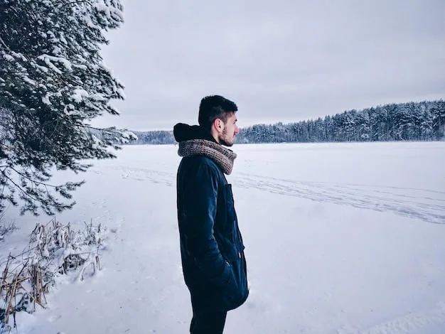 A person braving a snowy winter landscape, dressed in a sophisticated layered outfit including thermal base layers, a chunky cable-knit sweater, a tailored wool coat, a cashmere scarf, and leather gloves, exuding warmth and elegance.