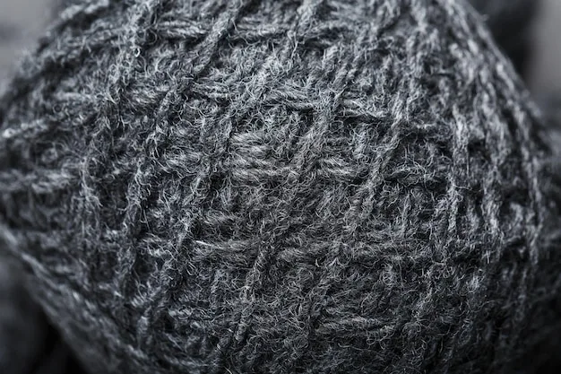 A close-up shot of a high-quality wool fabric, showing intricate weave and rich texture, emphasizing the meticulous craftsmanship and durability of premium materials.