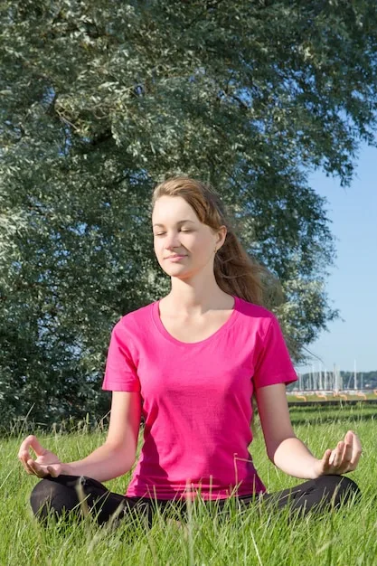 A woman meditating peacefully after a workout, showcasing the stress-reducing benefits of exercise on her calm facial expression.