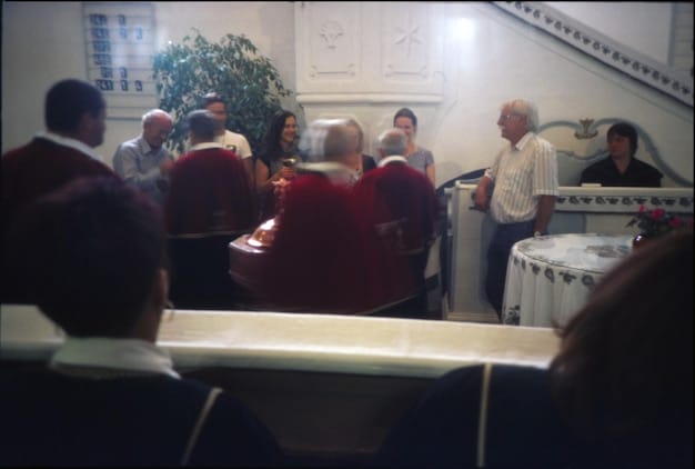 A split image showing a town hall meeting on one side and a group of people voting on the other. The images illustrate the importance of civic participation and the power of community voices in shaping governmental policies.