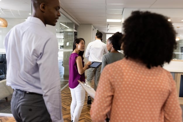 A diverse group of workers participating in a job fair, engaging with recruiters and exploring new career opportunities. The image symbolizes the importance of access to job resources and the potential for community partnerships to connect individuals with meaningful employment.