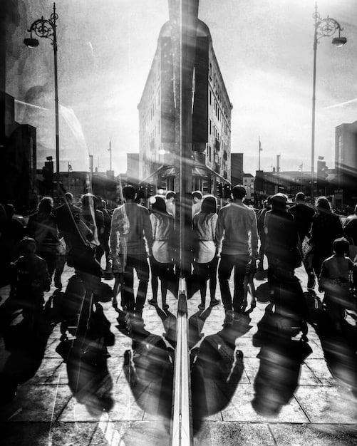 A split image showing a historical photo of a civil rights march for voting rights on one side, and a modern-day scene of people waiting in a long line to vote on the other.
