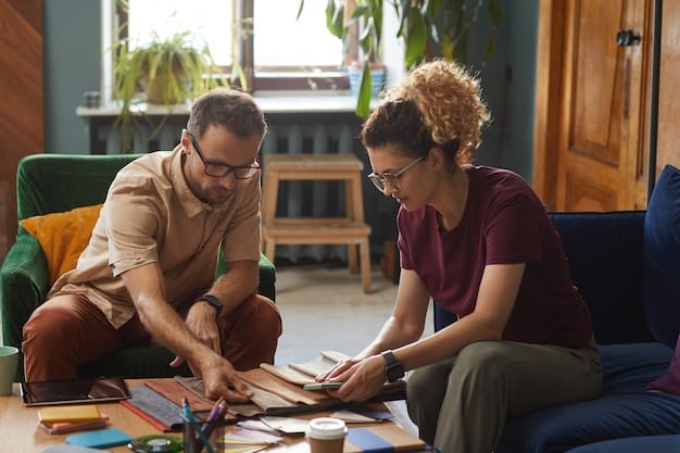 A mentor and a young artist are sitting together, reviewing a portfolio of the young artist's work. The mentor is pointing to a specific piece, providing constructive feedback. They are in a well-lit studio, surrounded by art supplies and finished artwork.