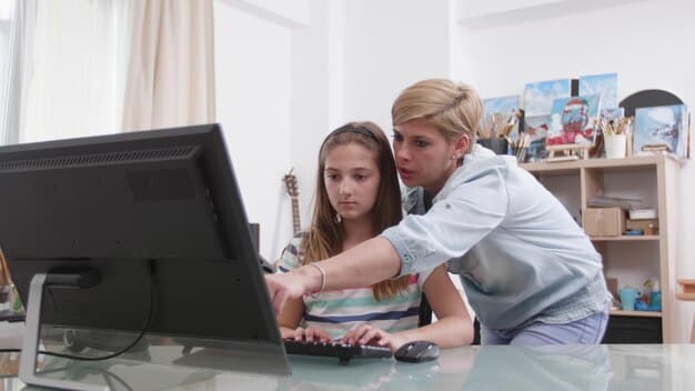 A student with a disability using assistive technology in a classroom, with a teacher providing support and guidance.