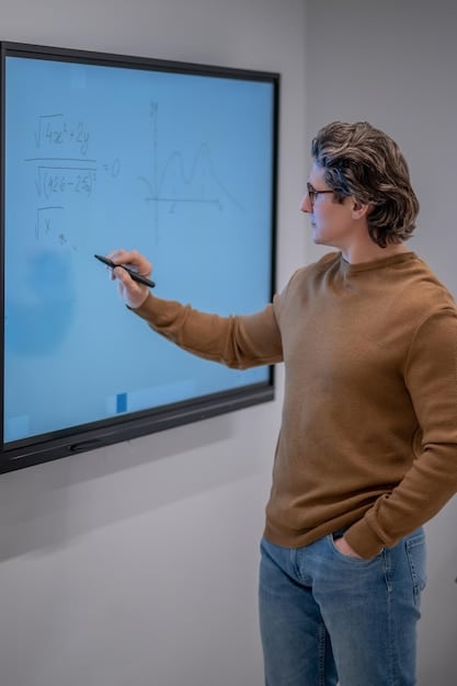 A close-up shot of a teacher using an interactive whiteboard to teach a math lesson. Students are actively participating, raising their hands and engaging with the material. The teacher is smiling and pointing to the board, creating an engaging learning environment.