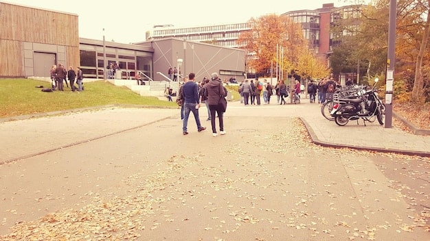 A panoramic view of a bustling college campus during orientation week, capturing the excitement and diversity of the student body. The scene includes students participating in activities, exploring campus facilities, and interacting with faculty.