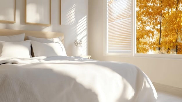 A brightly lit small apartment bedroom featuring a queen-sized bed with white and beige SHEIN Home bedding, minimalist nightstands, a tall mirror reflecting natural light, and a small plant, conveying a serene and spacious feel despite its size.