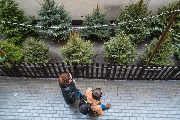 An overhead shot of a small, well-decorated US apartment balcony featuring compact SHEIN outdoor furniture, string lights, and potted plants, demonstrating efficient space utilization.