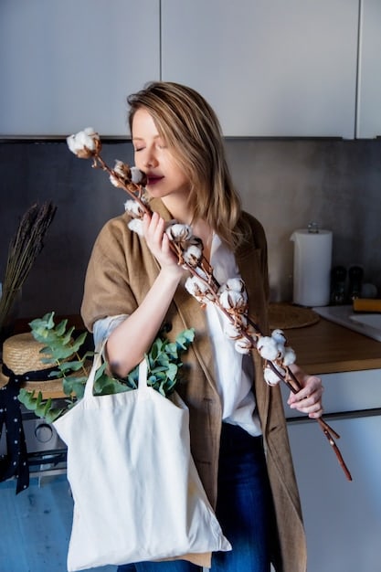 A person gently wiping down a clean, styled SHEIN tote bag with a soft cloth, showcasing the ease of maintenance, set against a blurred background of a well-organized closet.