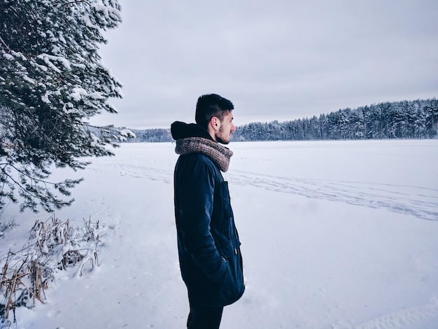 A person braving a snowy winter landscape, dressed in a sophisticated layered outfit including thermal base layers, a chunky cable-knit sweater, a tailored wool coat, a cashmere scarf, and leather gloves, exuding warmth and elegance.