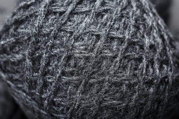 A close-up shot of a high-quality wool fabric, showing intricate weave and rich texture, emphasizing the meticulous craftsmanship and durability of premium materials.